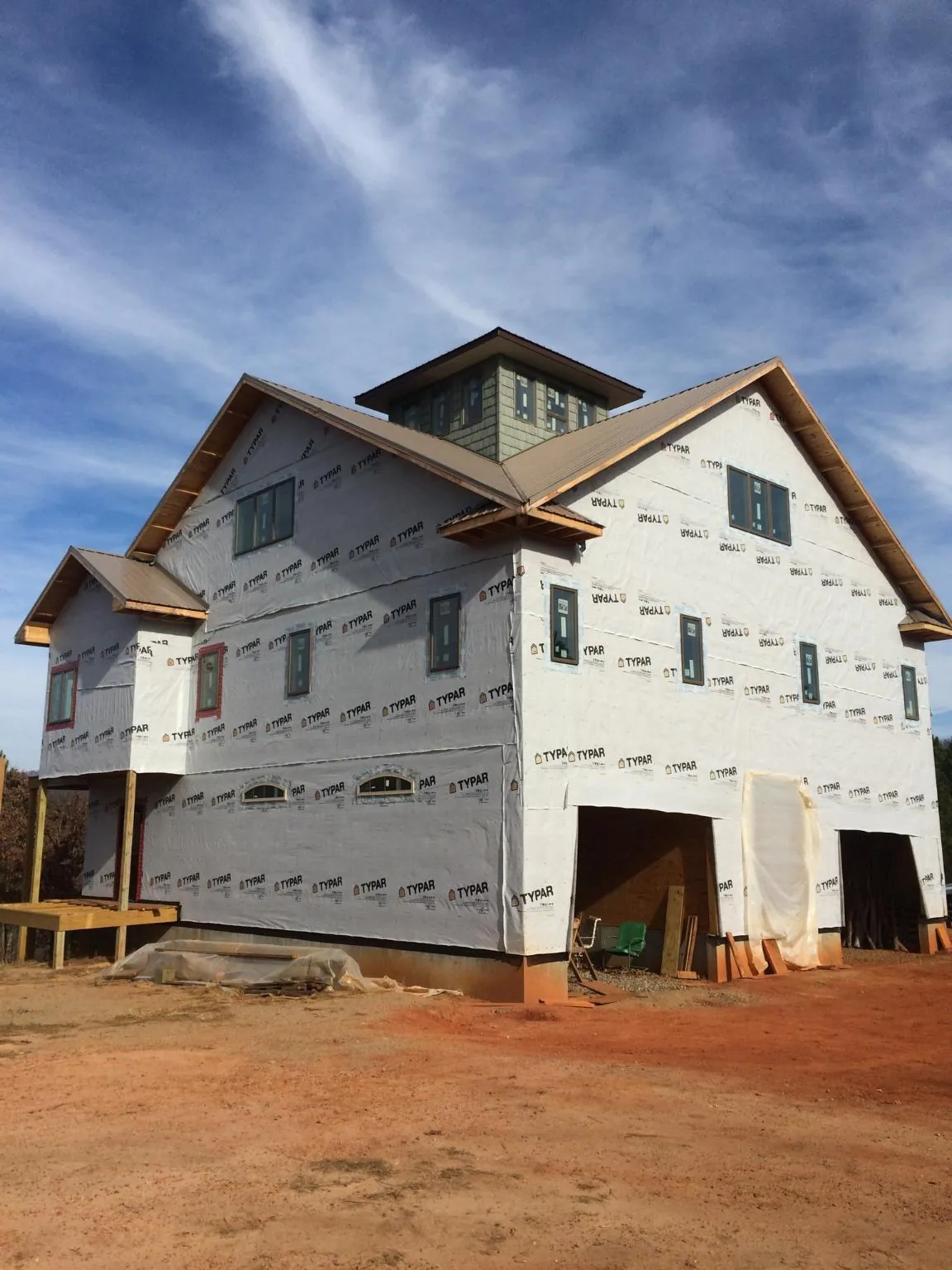 New two story house under construction with a cupola and gabled roofs in Kerkhoven